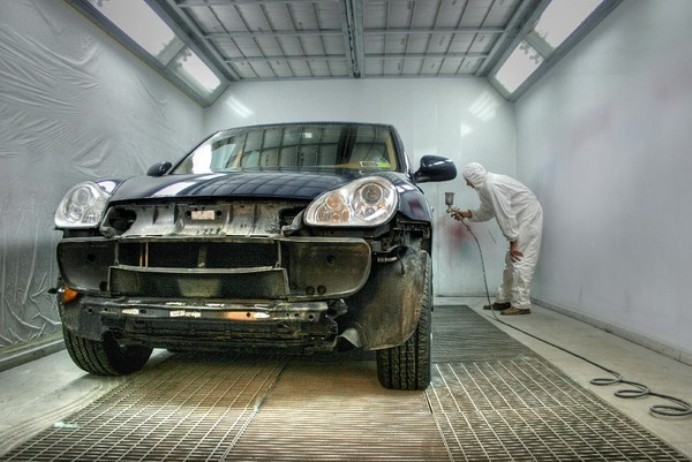 Автомаляр красит машину краскопультом Автомаляр красит машину краскопультом